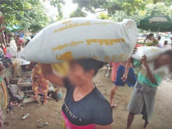 A woman carrying a bag of food