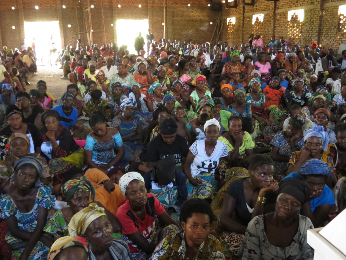 A large congregation inside a basic church building