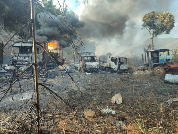 Several burned out buildings, one on fire