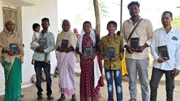 A group of people holding Bibles