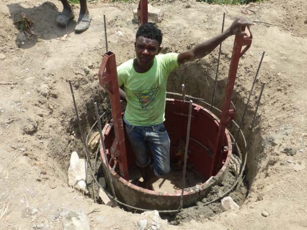 A man standing in a partly built well