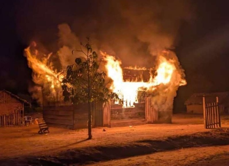 A burning building in a rural area