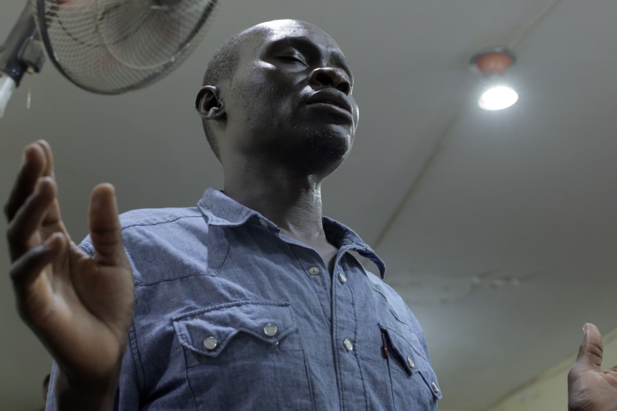 A man raising his hands in worship