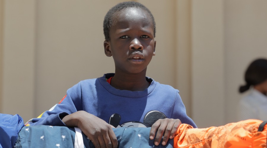 A young boy in a blue t-shirt