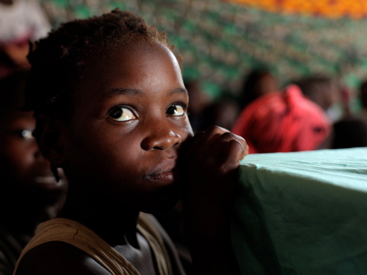 A young girl looks up at the camera