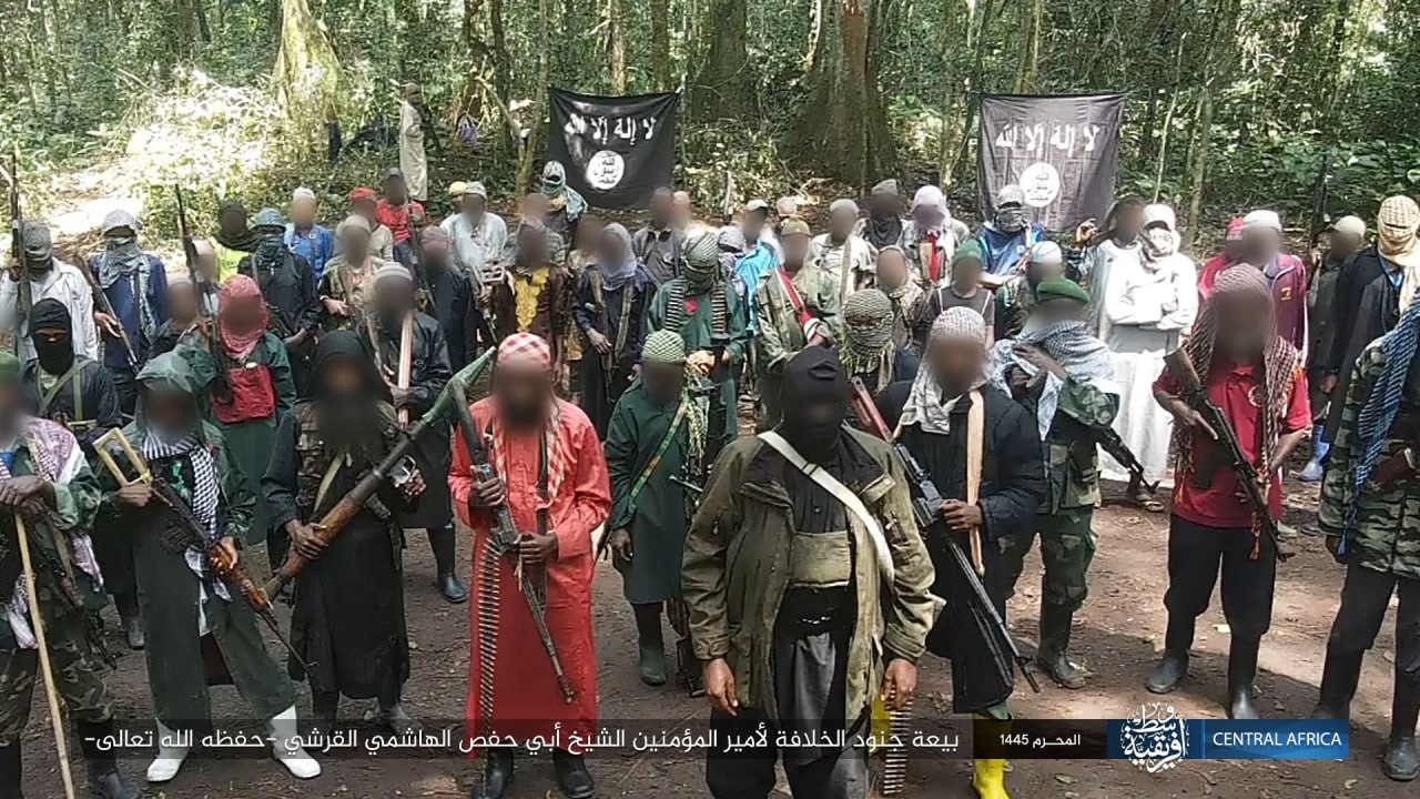 A crowd of men holding weapons