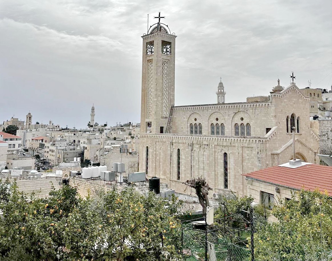 A church building with a cross and spire