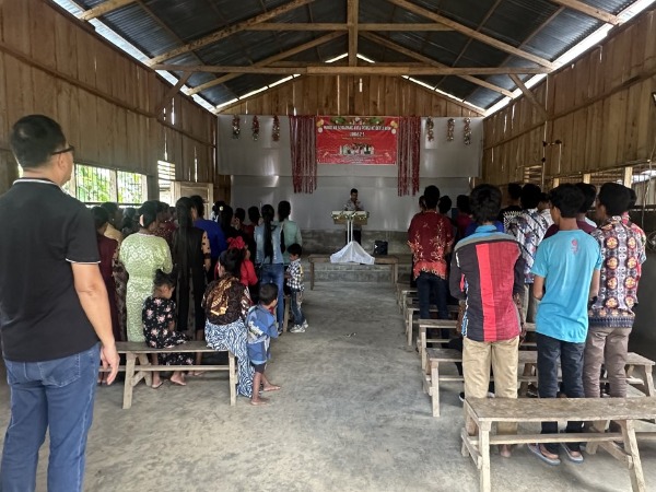 A small congregation in a very basic church building