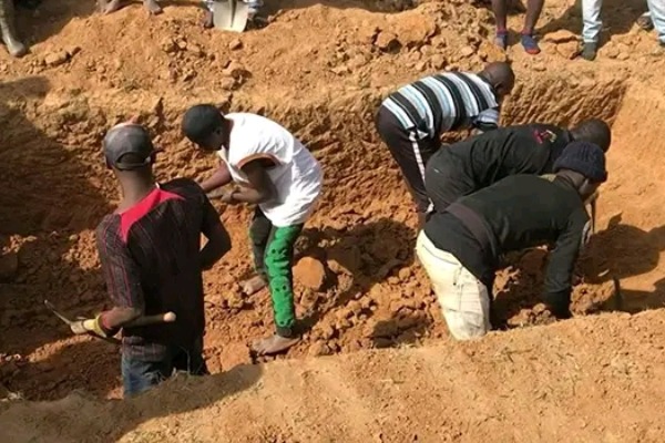 A group of men digging a large hole