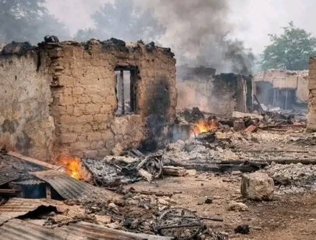 Smoke rising from destroyed and burned buildings with rubble on the ground
