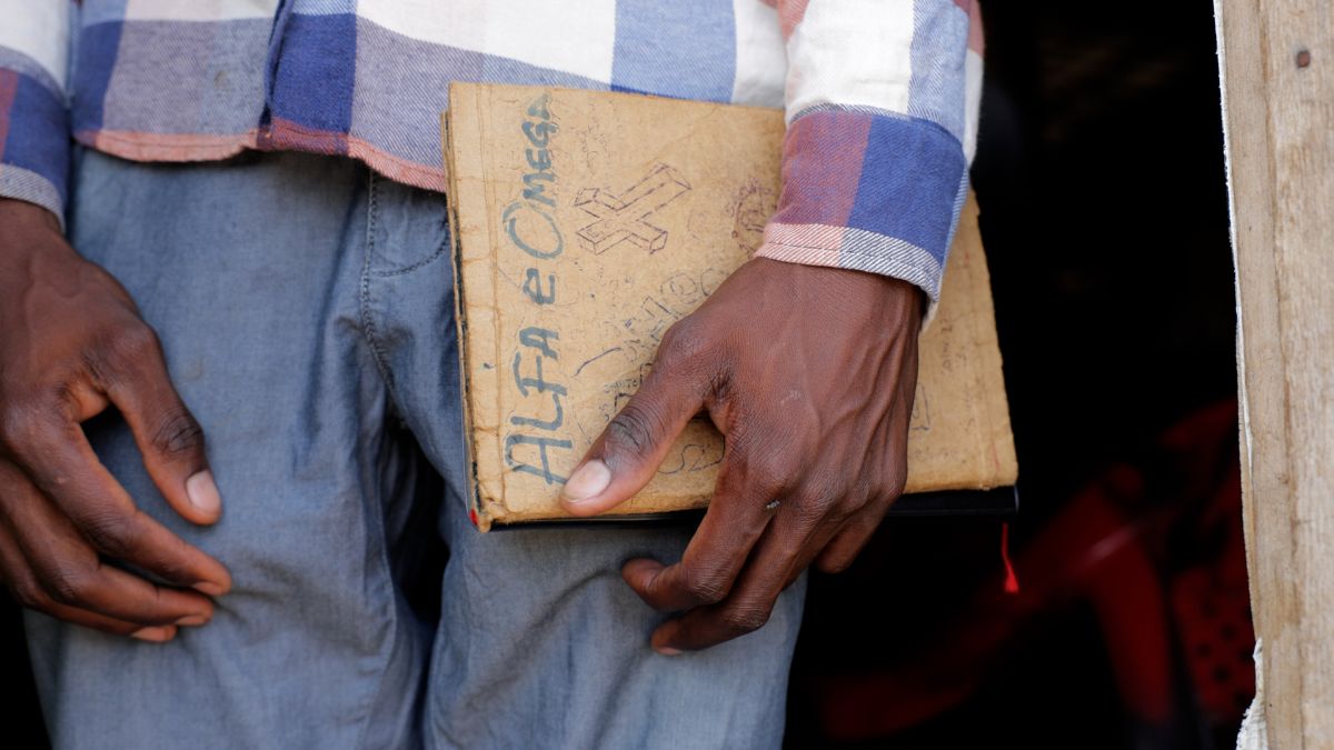 Hands holding a page of Scripture