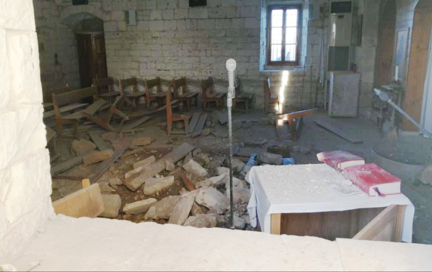Bibles on a table in a destroyed building