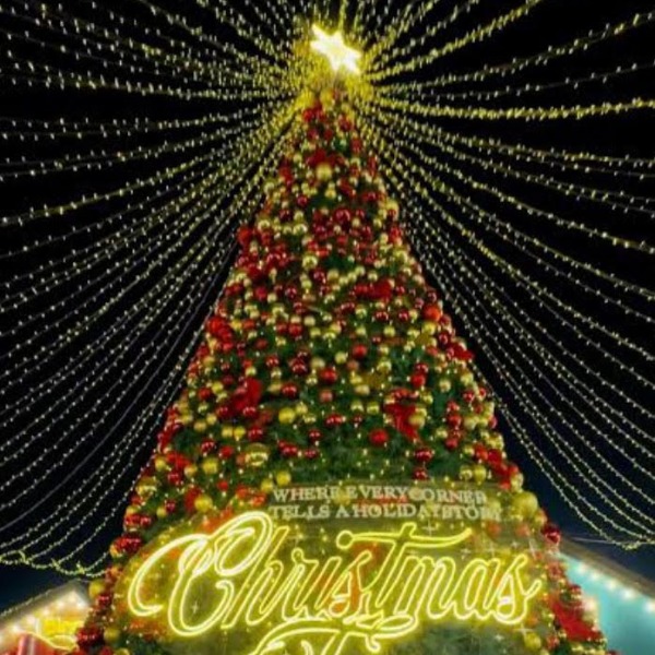 Brightly decorated tree with "Christmas" written on the front