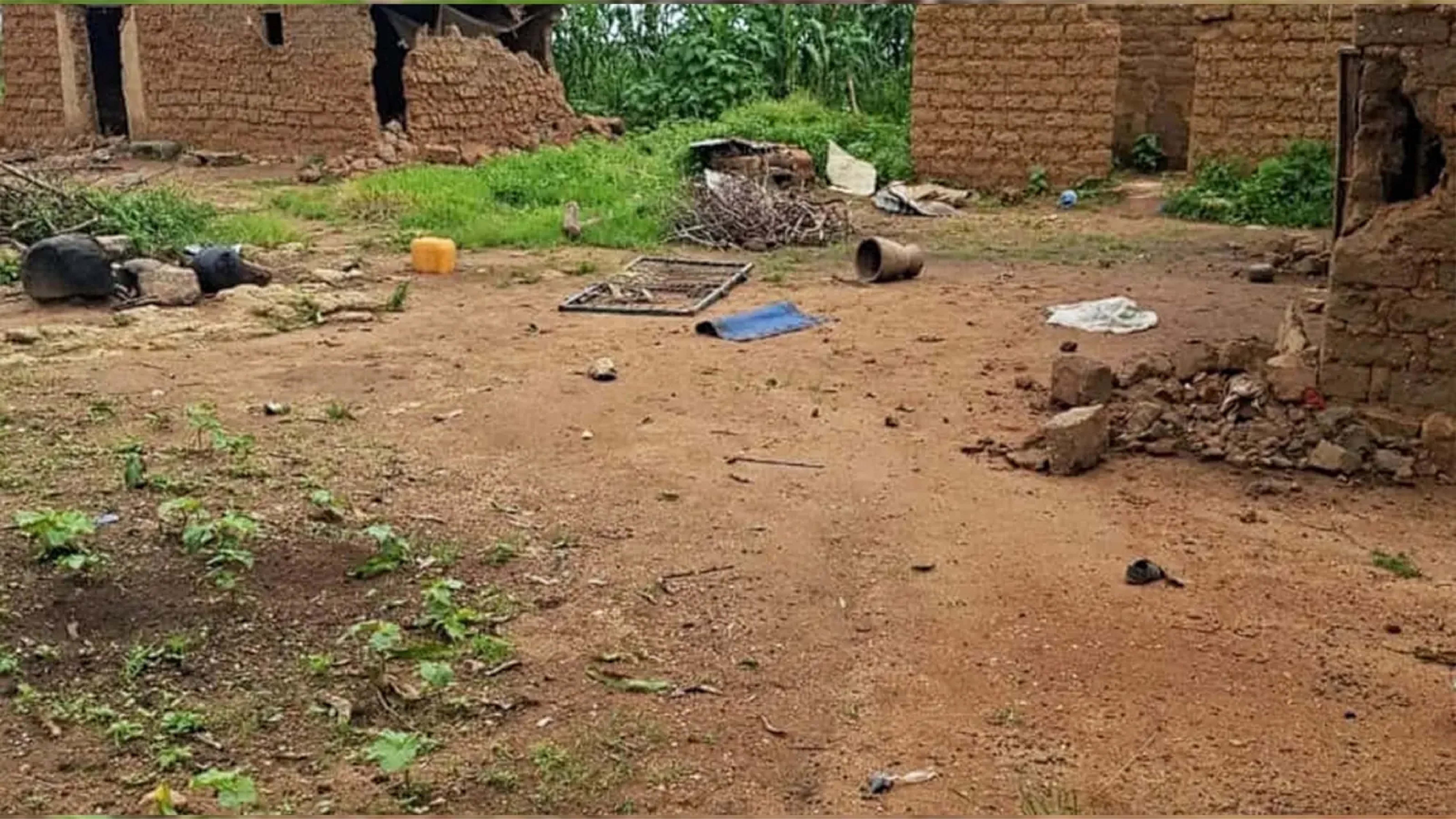 Debris on ground around ruined houses