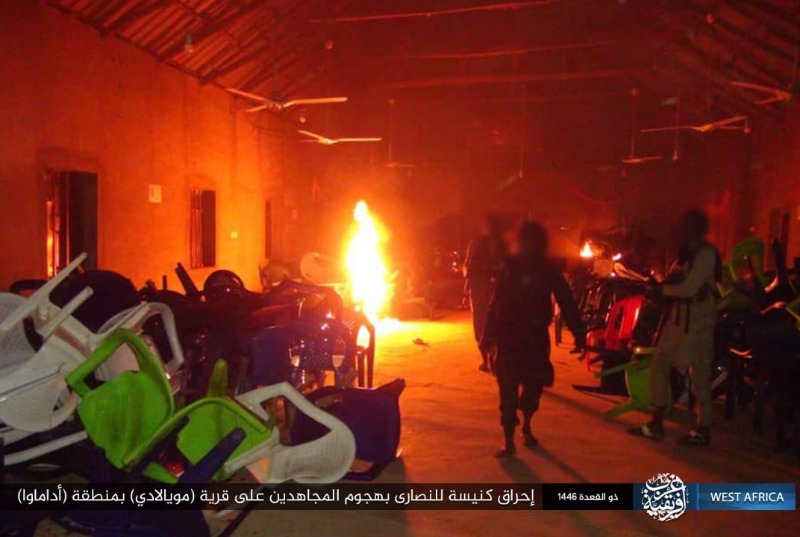 Men pile up furniture inside a church building on fire