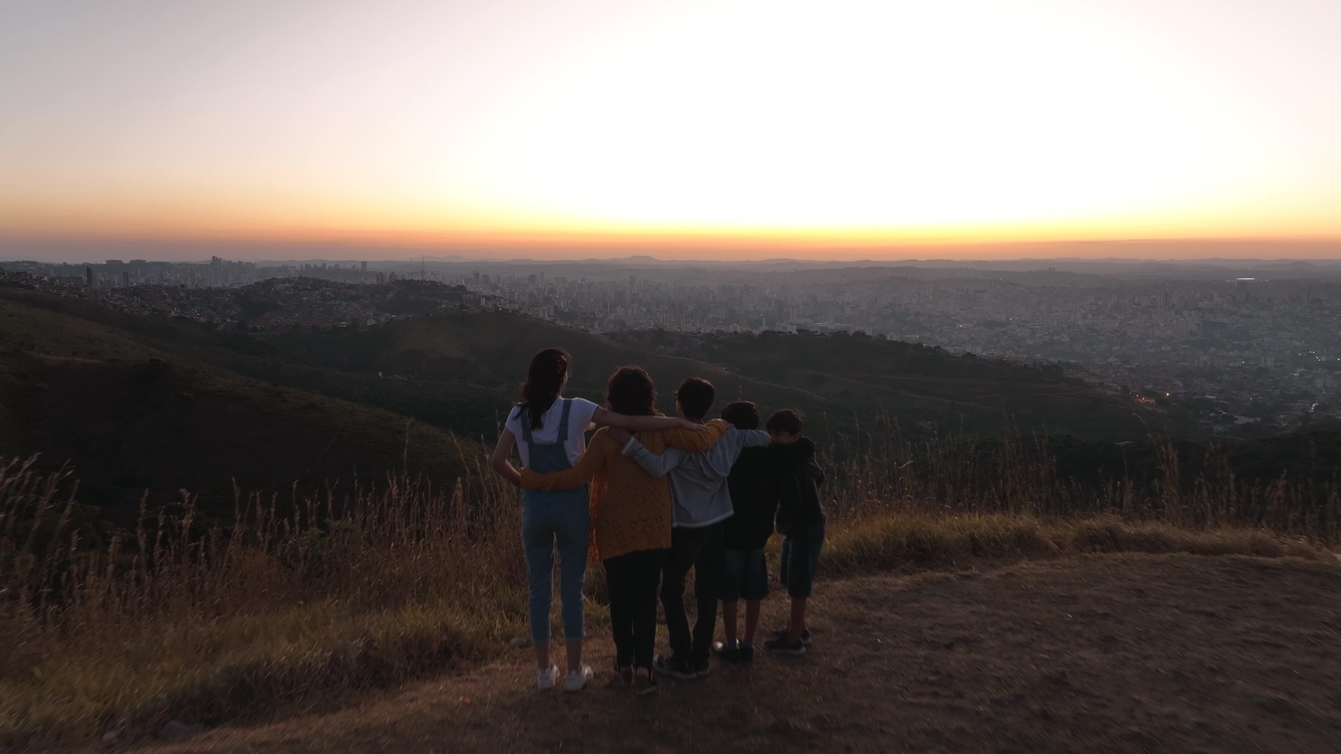 Vangai and her family stand on a hillside looking over the land of Brazil.