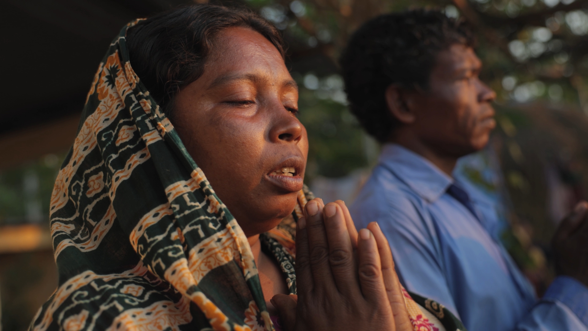 Christian man and woman praying in Bangladesh